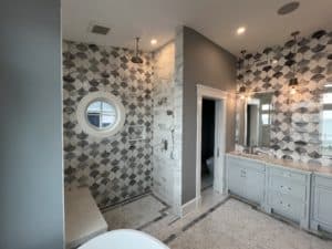 bathroom with patterned tile wall